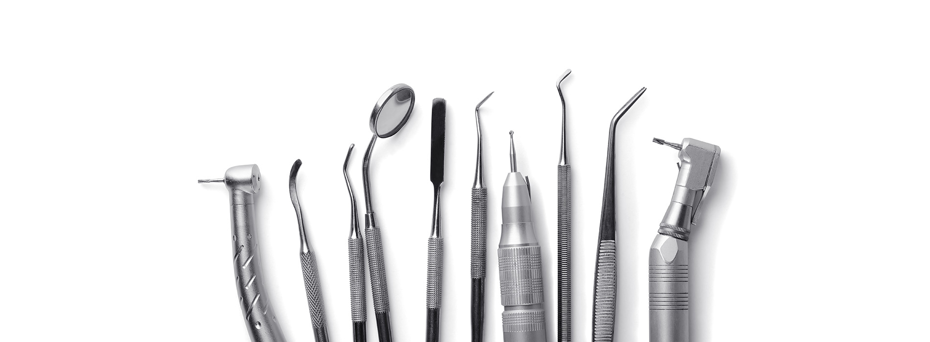 The image shows a collection of dental tools, including various types of drills and pliers, arranged in rows on a white background.