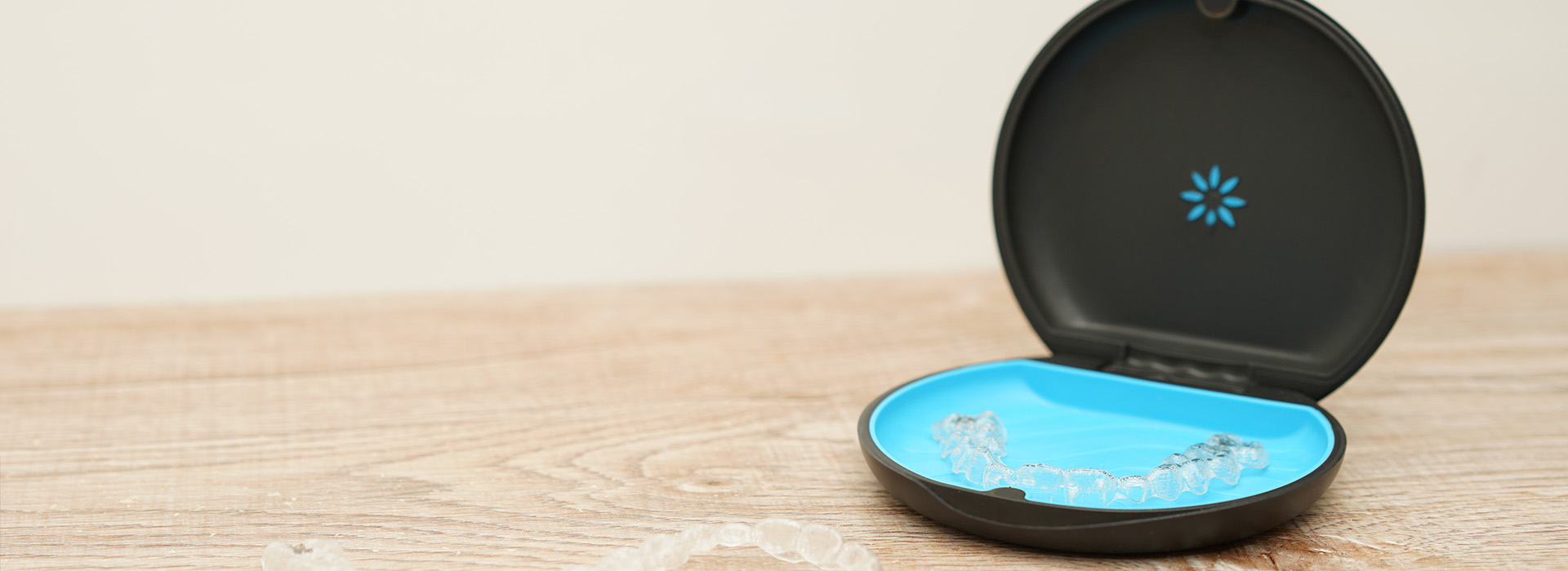 An image of a smartphone charging dock with a blue circular design on the front, placed against a light-colored background.